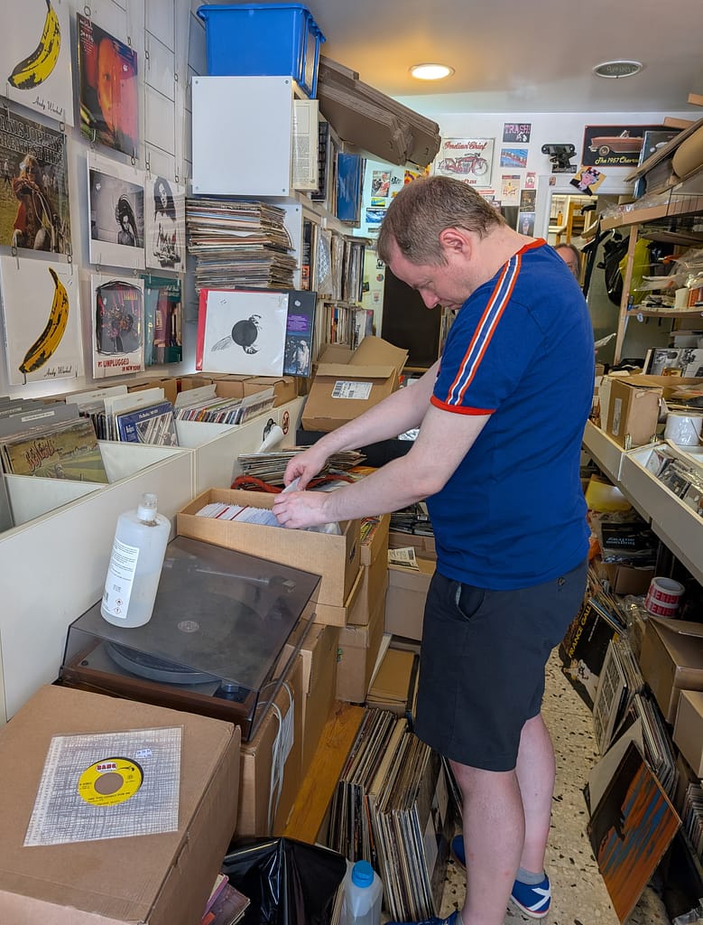 Browsing 45rpm records inside Sonic Import record shop in Nice, France.